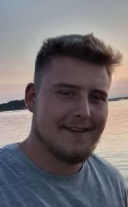 Bradley selfie with ocean behind him at sunset